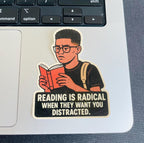 A sticker with an illustration of a person reading a book, accompanied by the text "Reading is Radical When They Want You Distracted."