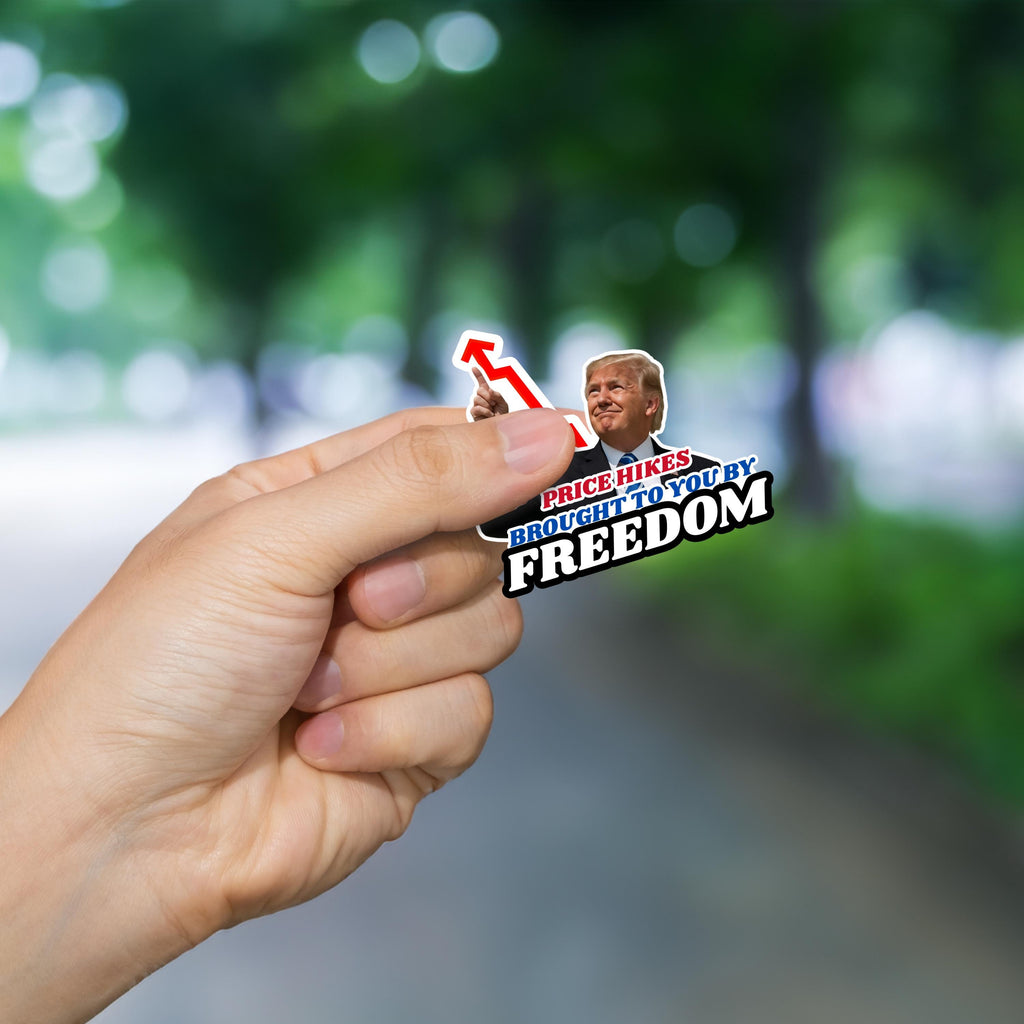 A person's hand holding a sticker with a political message.
