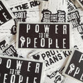 Stickers with 'Power to the People' text and graphics on a white background