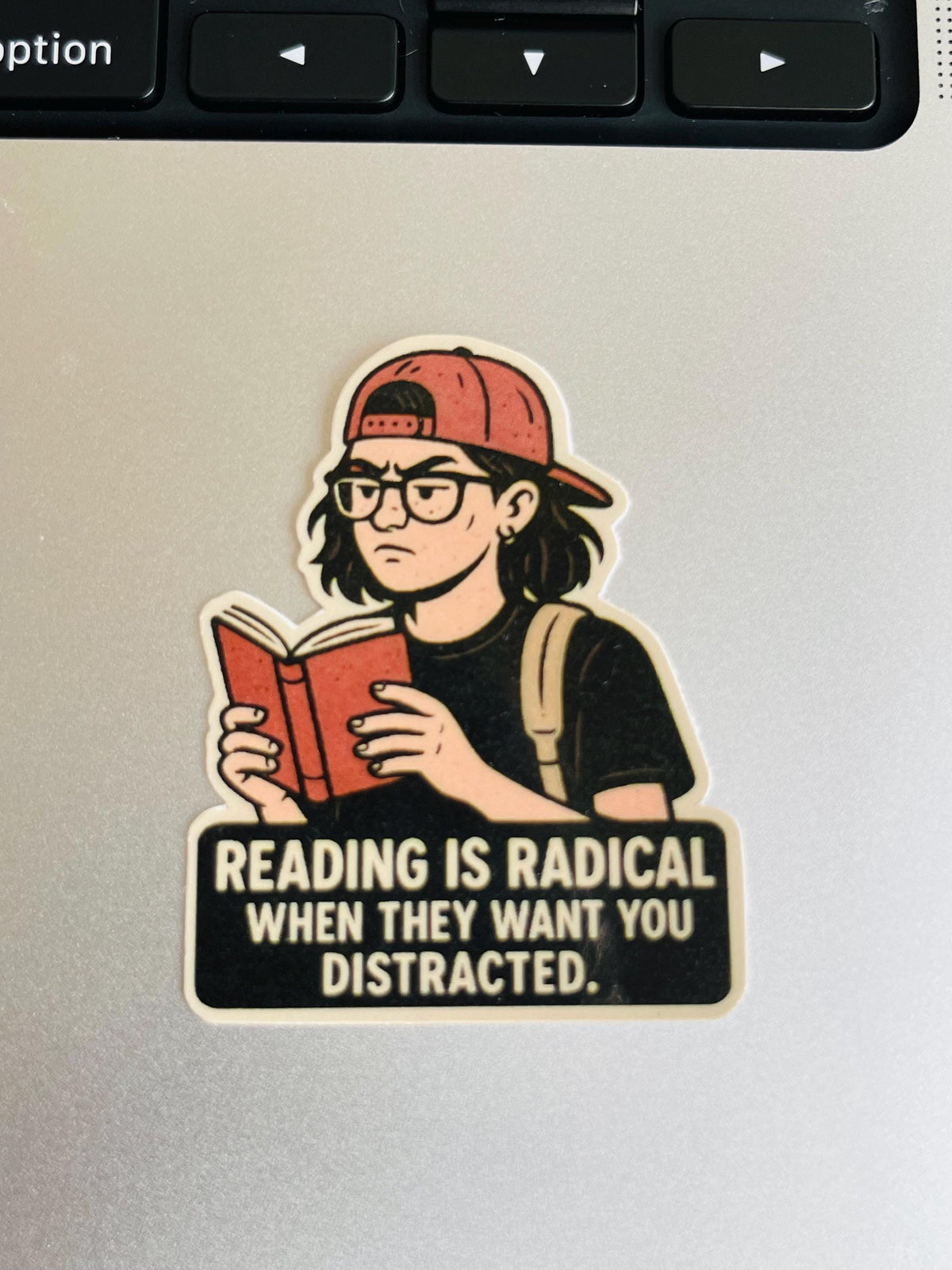 "Reading Is Radical When They Want You Distracted" Vinyl Sticker – Bookish Resistance Quote for Teens