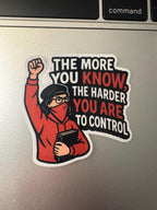 A sticker with a person wearing a red hoodie and a black bandana, with the text "The more you know, the harder you are to control" written on it.