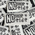 multiple stickers with the text "NO JUSTICE / PEACE" printed on them.